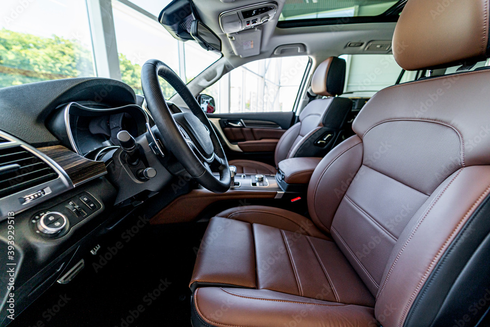 Modern supercar interior with leather panel, sport seats, multimedia and digital dashboard. Closeup.