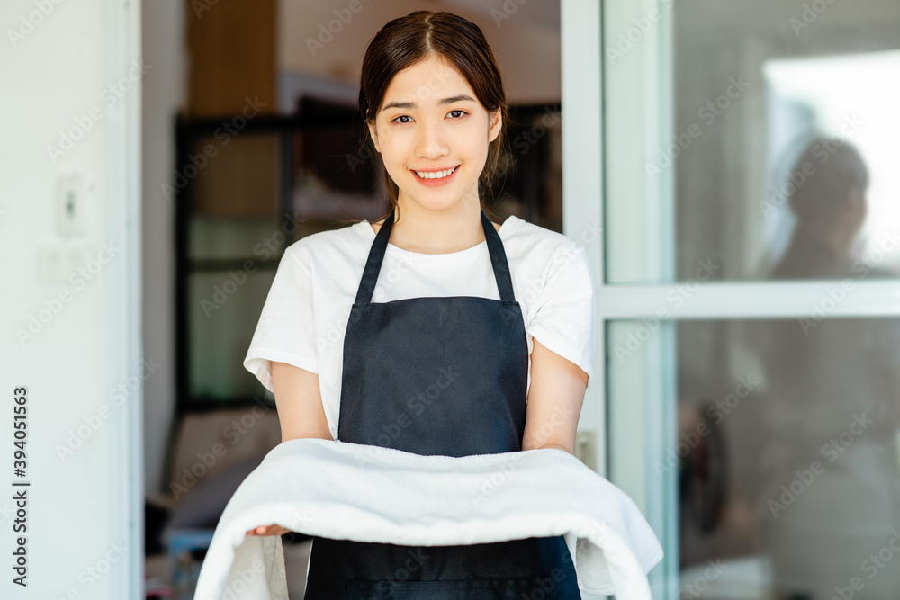 一名亚洲女服务员正在为客人准备毛巾