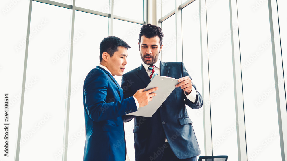 Two business people talk project strategy at office meeting room. Businessman discuss project planni