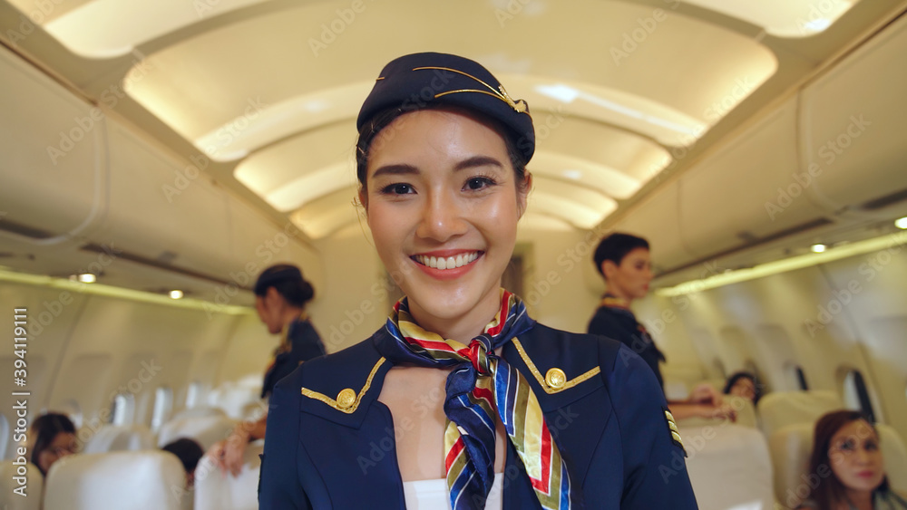 Cabin crew or air hostess working in airplane . Airline transportation and tourism concept.