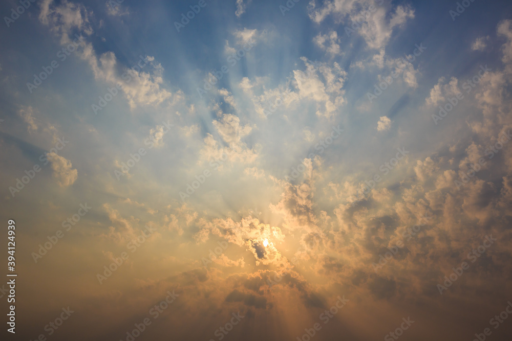 The sky is covered with clouds and the suns rays penetrate