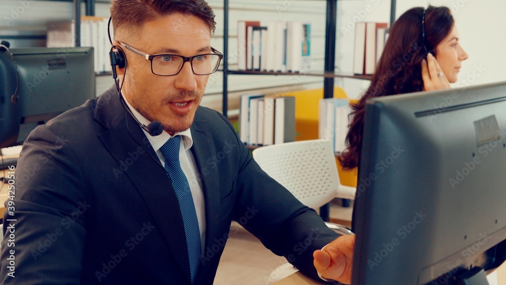 Business people wearing headset working in office to support remote customer or colleague. Call cent