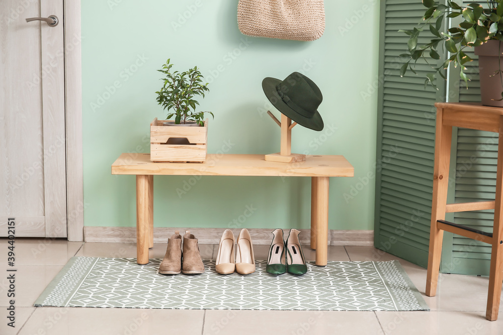 Stylish interior of modern hall with table and shoes