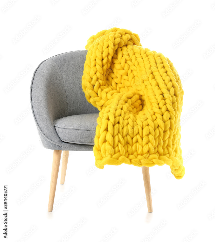 Armchair with knitted plaid on white background