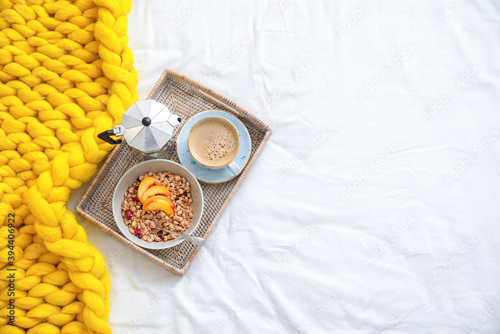 Tray with tasty breakfast on bed, top view