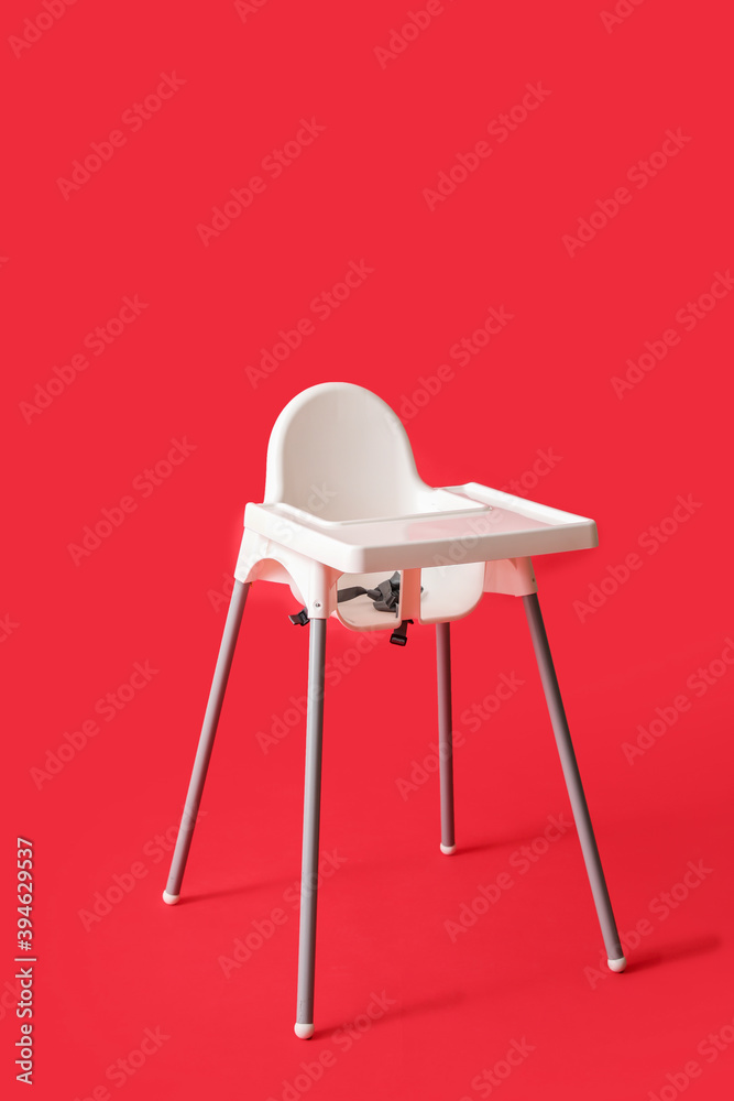 Baby highchair on color background