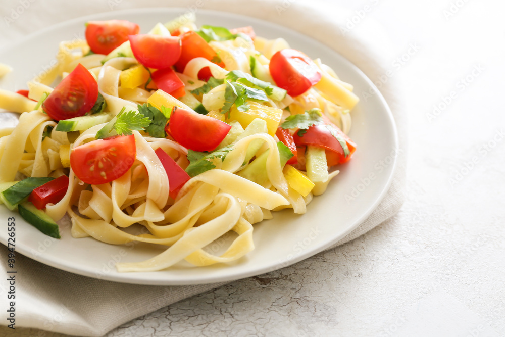 Plate with tasty pasta primavera on table