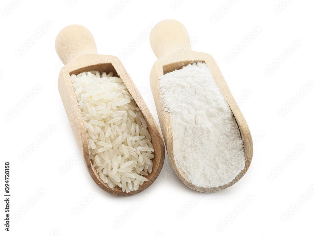 Scoops with rice and flour on white background