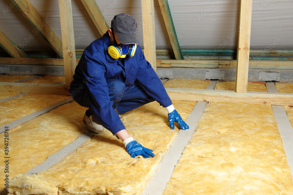 Man installing thermal roof insulation