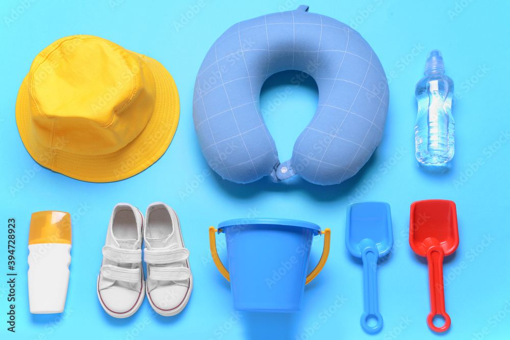 Flat lay composition with child beach accessories on color background. Travel concept