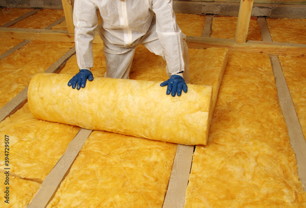 Worker insulate the attic with mineral wool