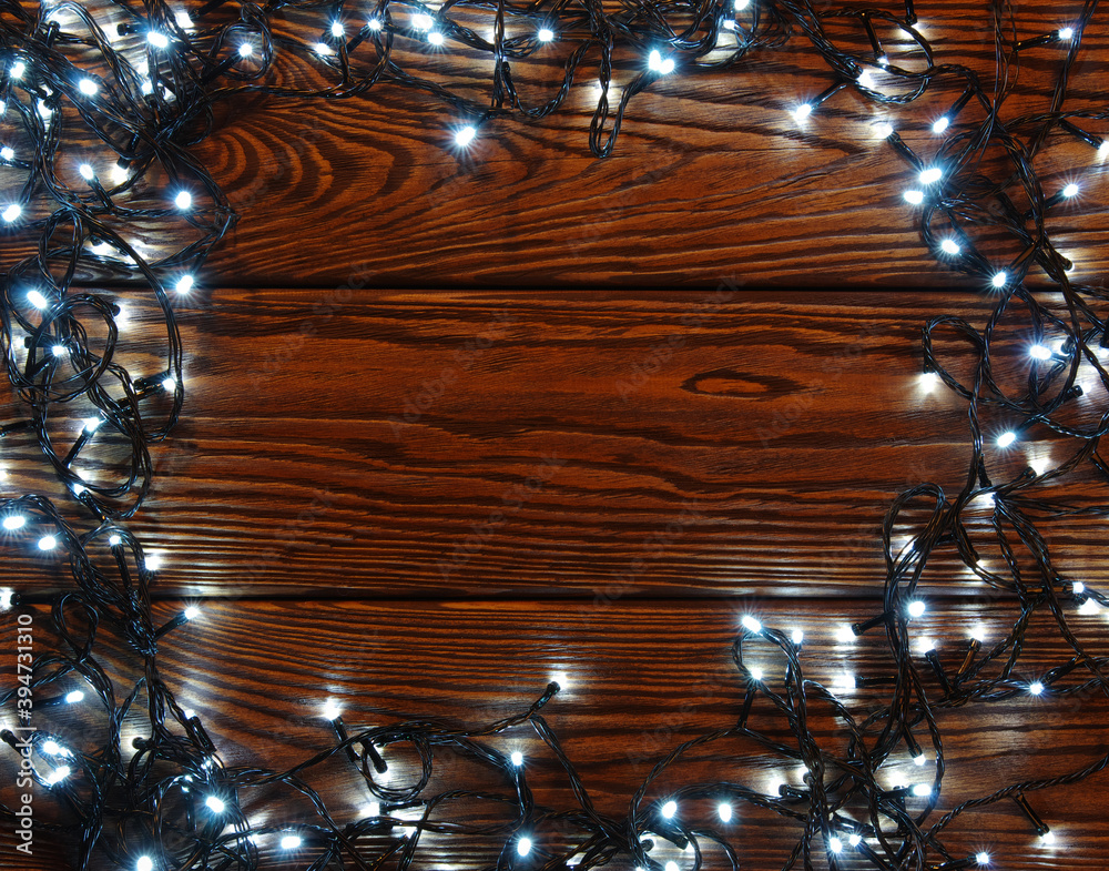 Сhristmas lights, background  ornaments on wood