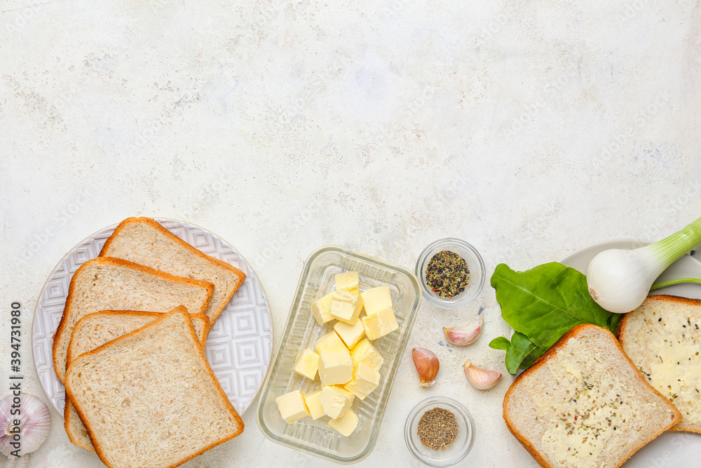 Diced butter in glass dish with spice and toasts on white table