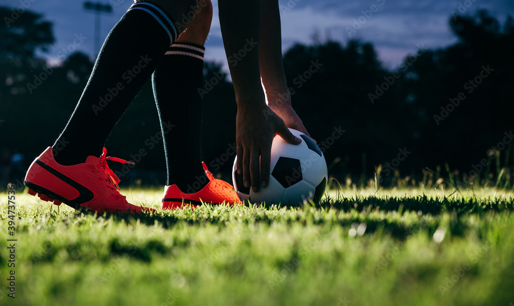 Football player kicking to soccer ball at free kick point.