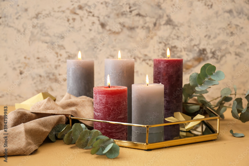 Tray with beautiful aroma candles on table