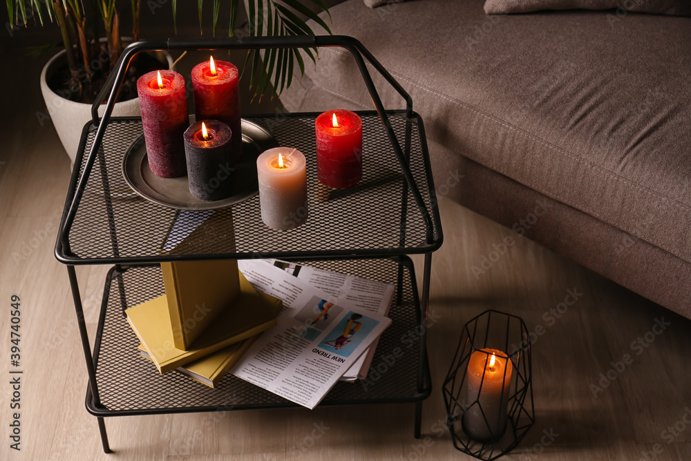 Beautiful aroma candles on table in dark room