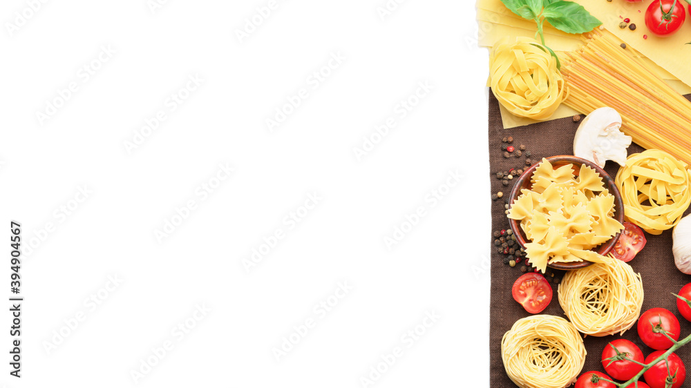 Assortment of uncooked pasta and vegetables on white background