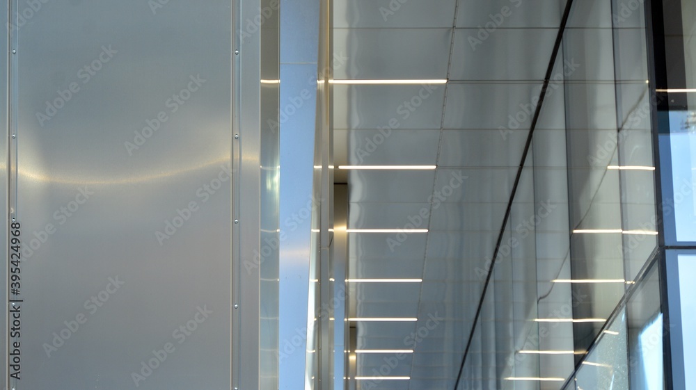 Combination of metal and glass wall material. Steel facade on columns. Abstract modern architecture.