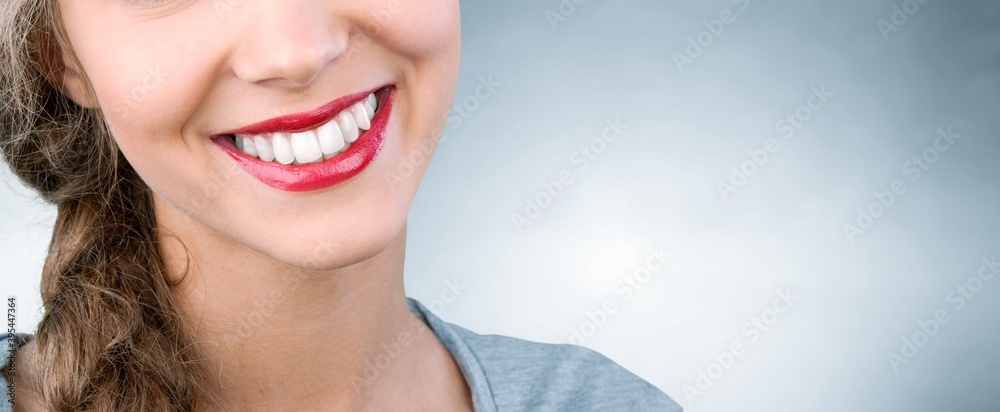 Beautiful smile of young woman with healthy white teeth