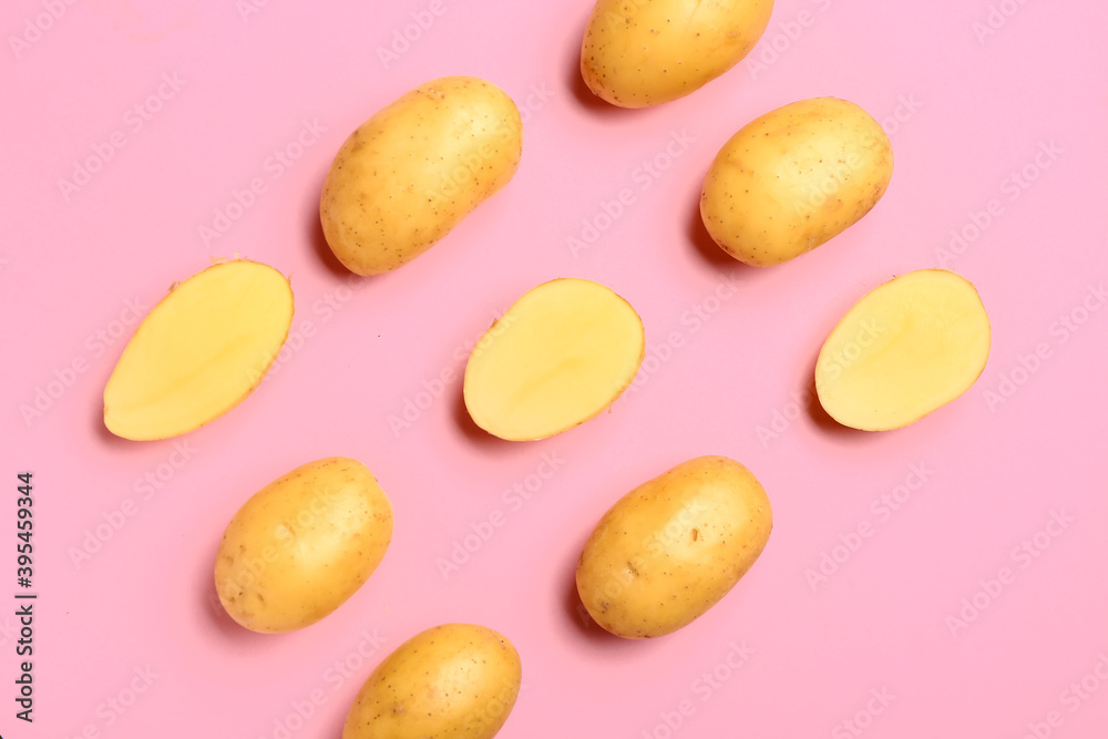 Raw potatoes on color background