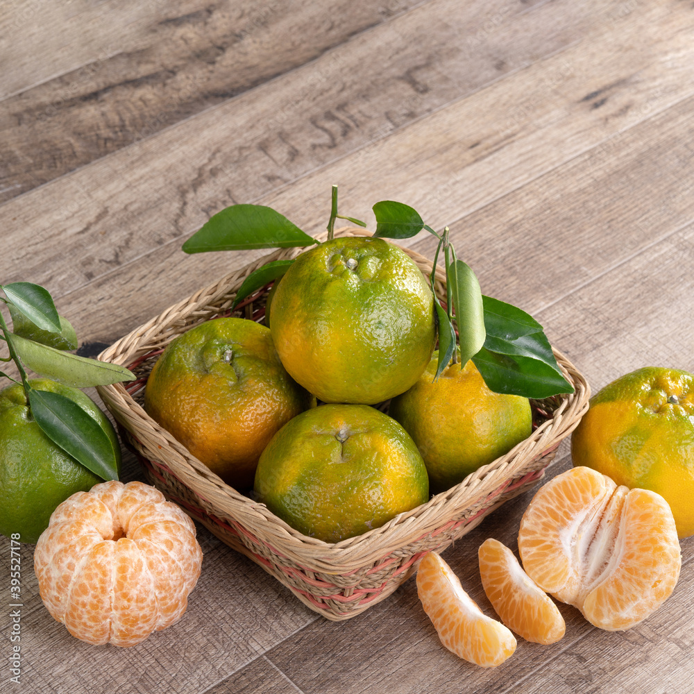 Fresh ripe tangerine mandarin orange on wooden table background.