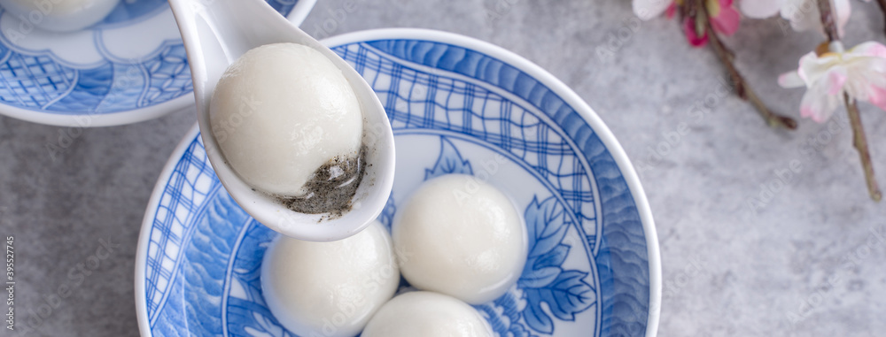 Top view of big tangyuan yuanxiao in a bowl on gray background for lunar new year food.