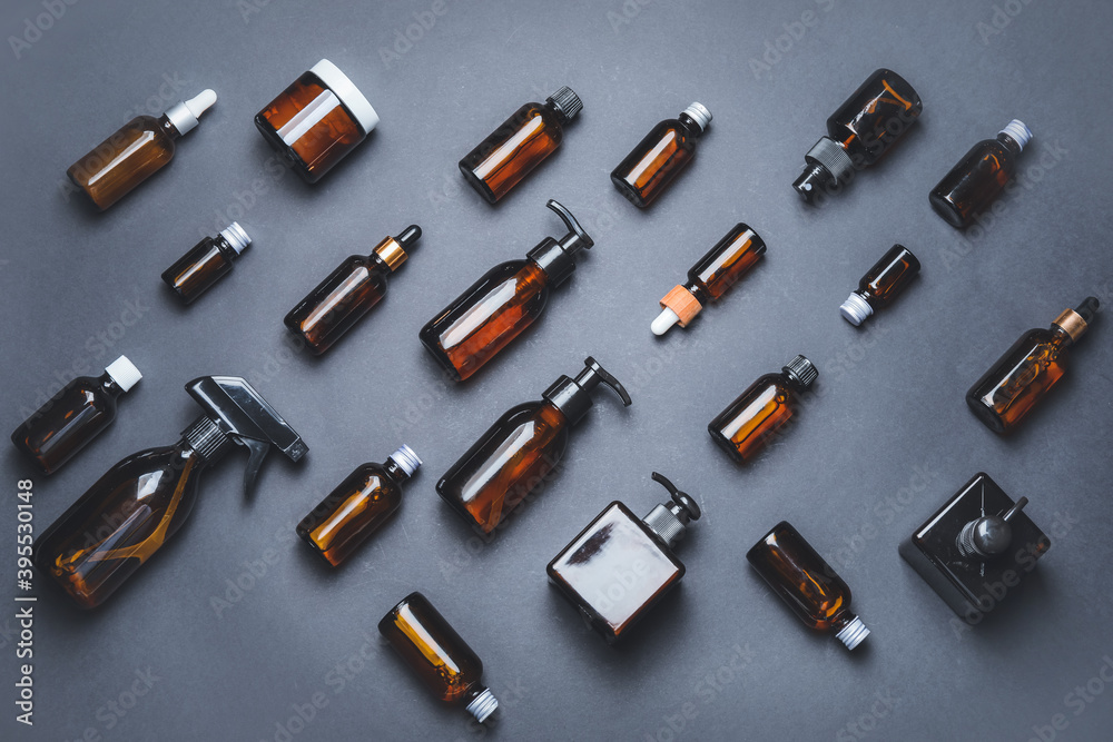 Composition with cosmetic bottles on dark background