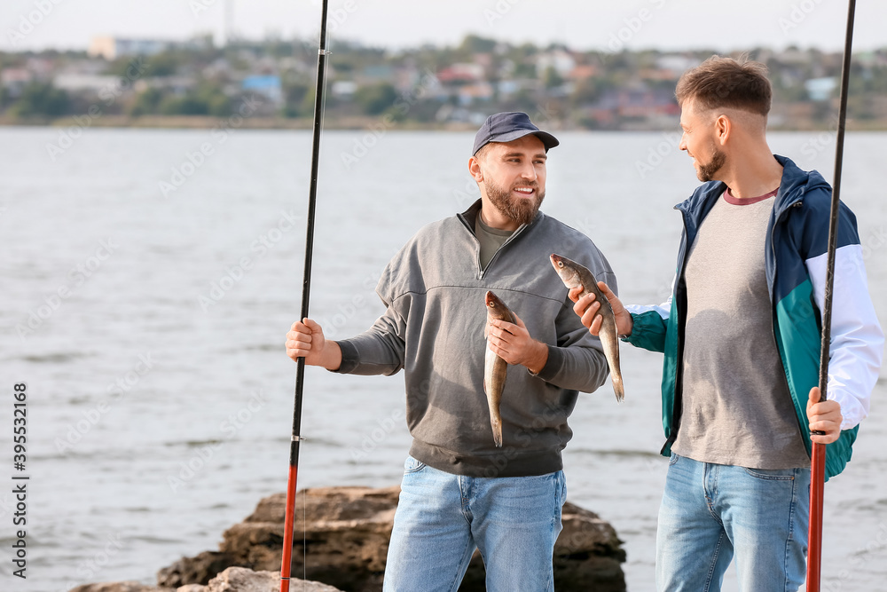 Young men fishing on river