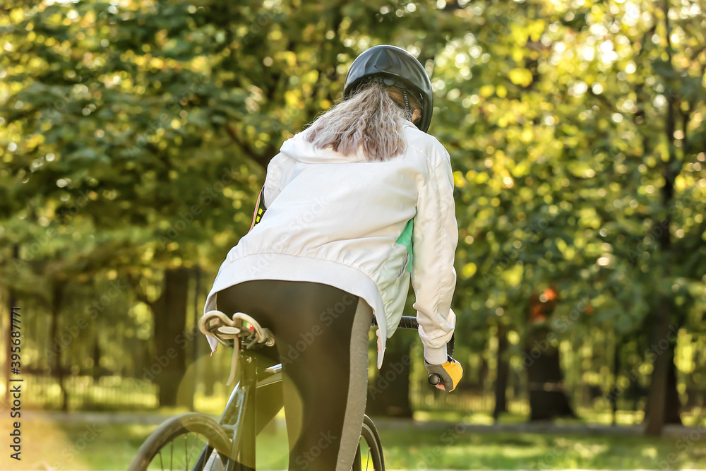 Female cyclist riding bicycle outdoors