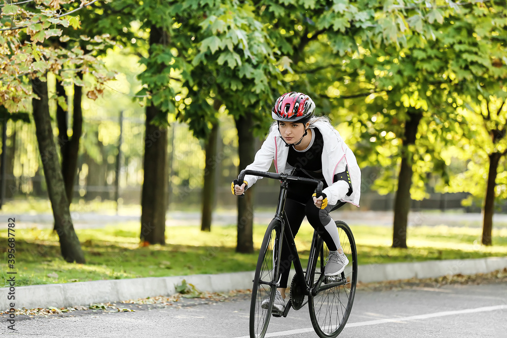 Female cyclist riding bicycle outdoors