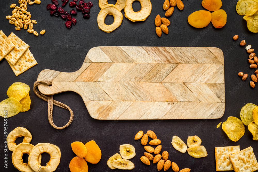 Healthy snacks overhead - nuts and dried fruits with crackers