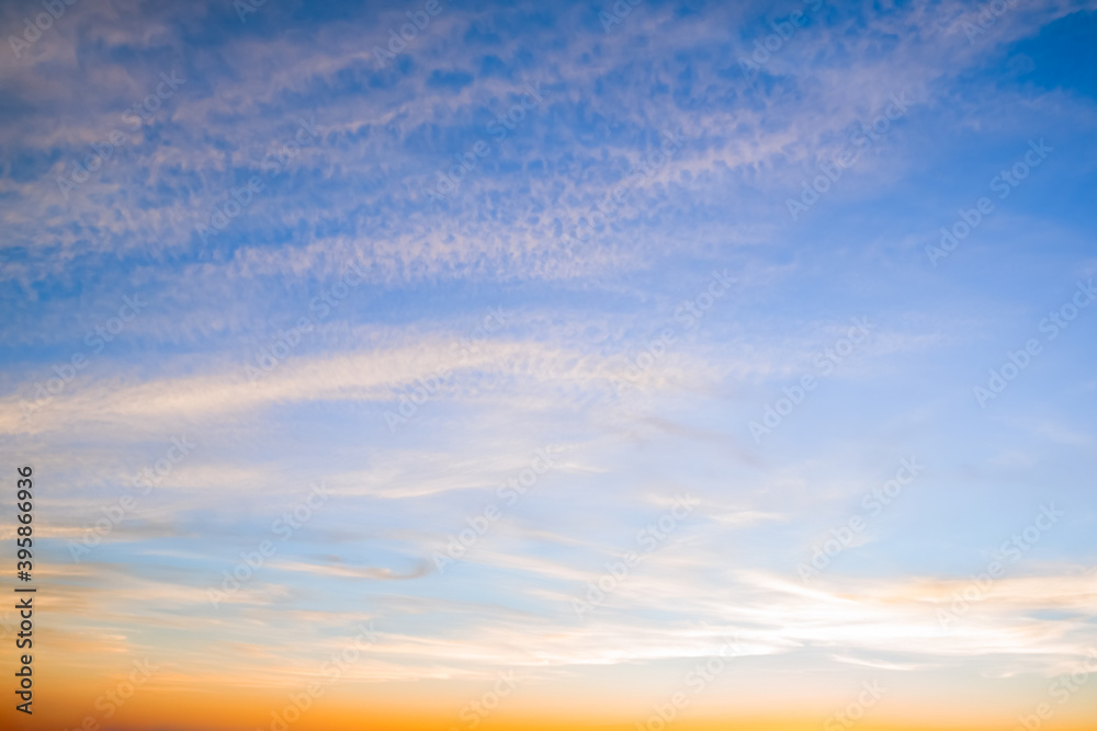 Blue sky with white and yellow clouds at sunset background