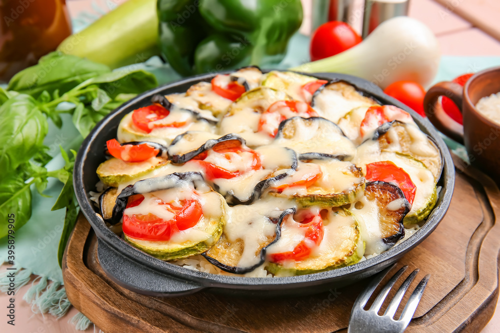 Baking dish with tasty rice casserole on table