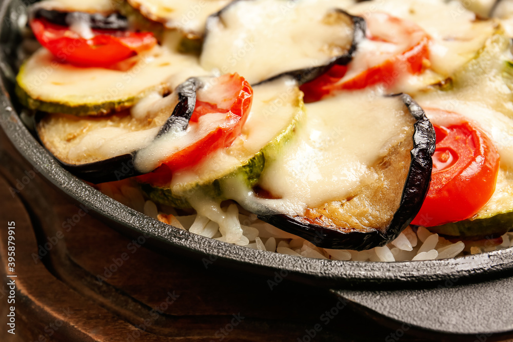 Baking dish with tasty rice casserole on table, closeup