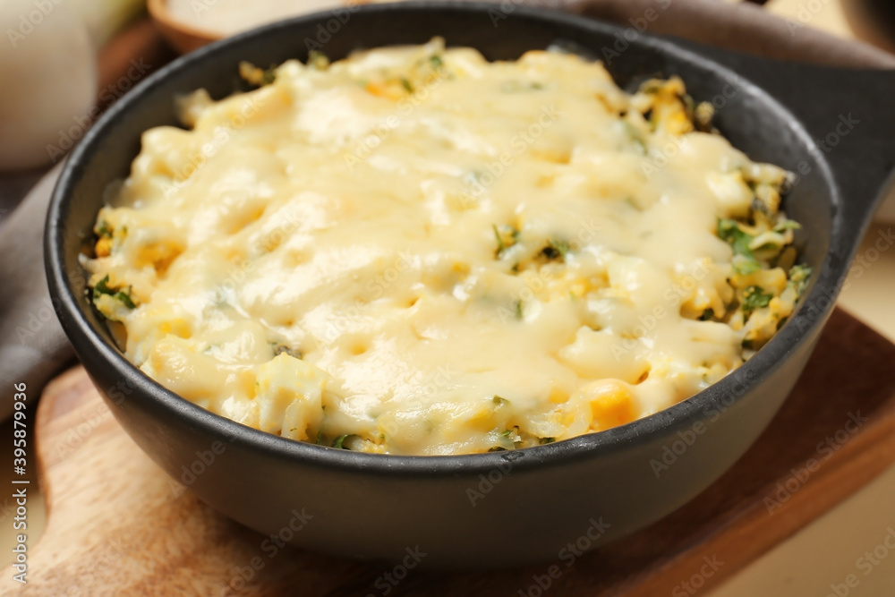 Baking dish with tasty rice casserole on table, closeup