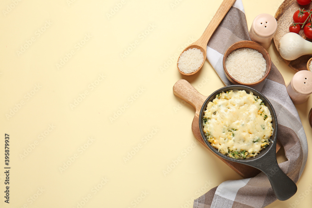 Baking dish with tasty rice casserole on color background