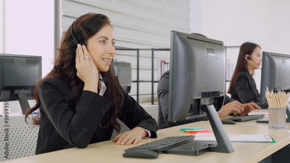 Business people wearing headset working in office to support remote customer or colleague. Call cent