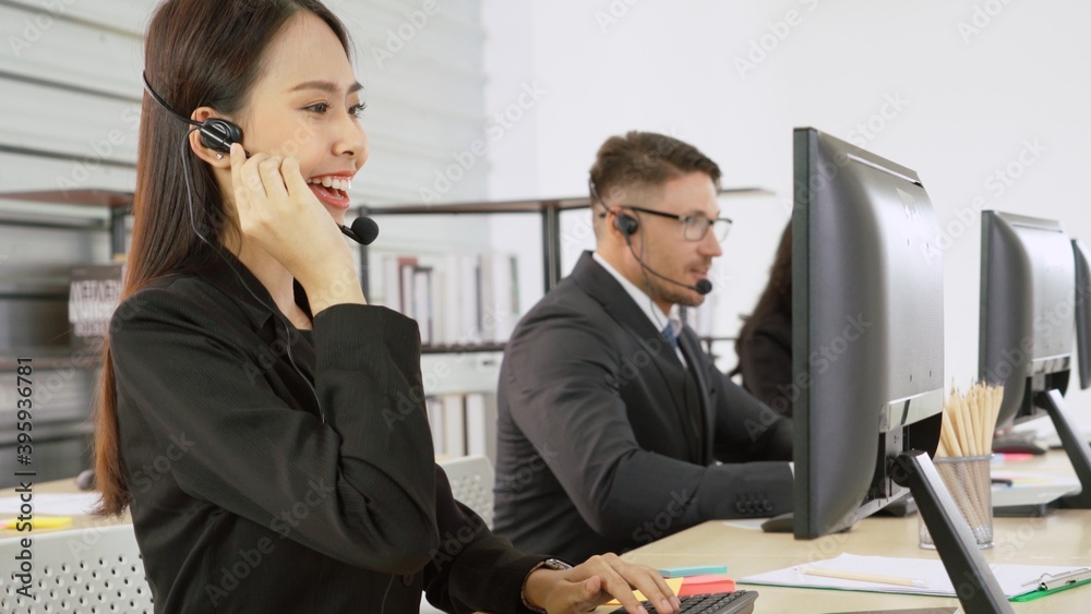 Business people wearing headset working in office to support remote customer or colleague. Call cent