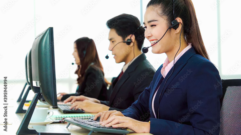 Business people wearing headset working in office to support remote customer or colleague. Call cent