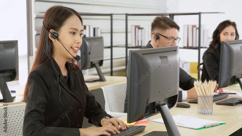 Business people wearing headset working in office to support remote customer or colleague. Call cent