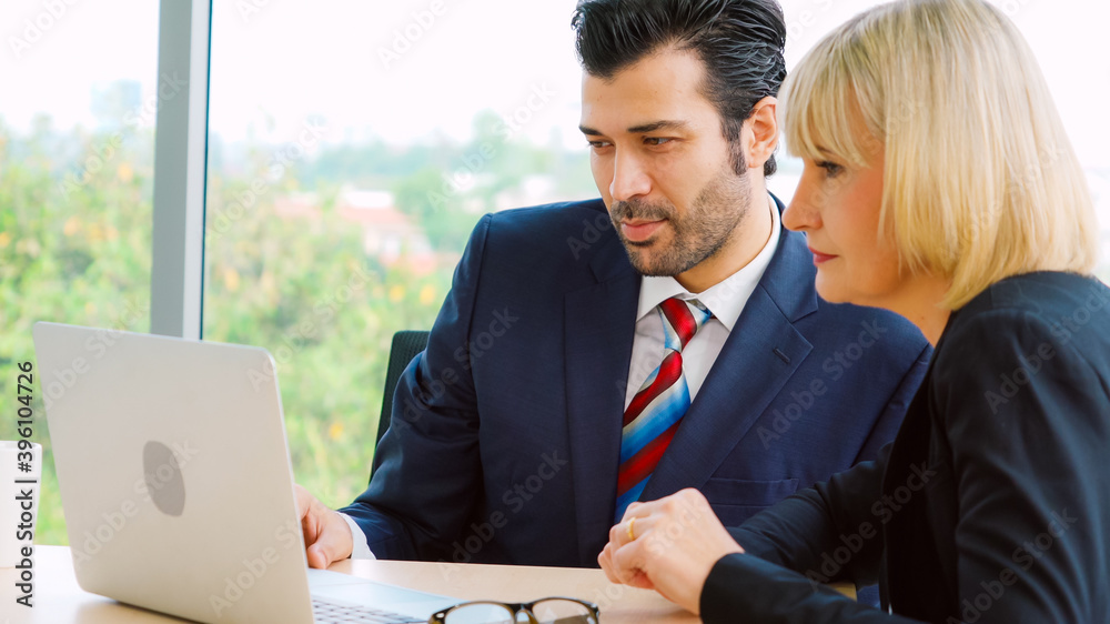 Two business people talk project strategy at office meeting room. Businessman discuss project planni