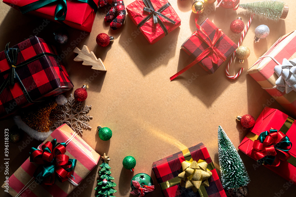 topview flatlay of present gift boxes with red color and ribbon wrap on wooden texture floor with de