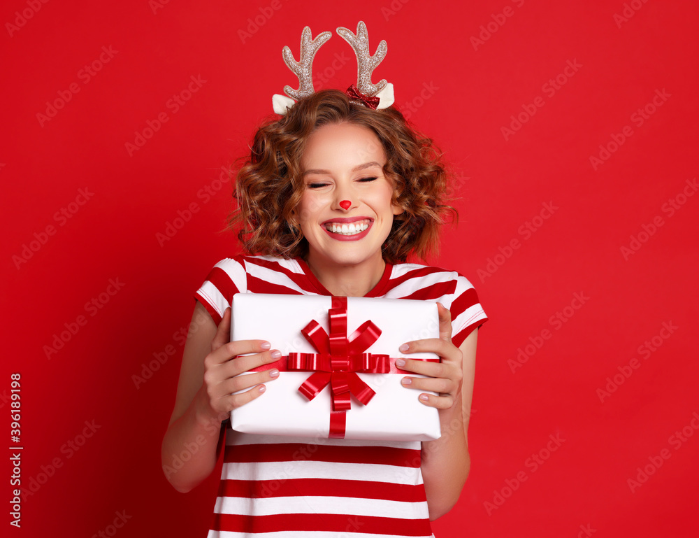 Cheerful female showing Christmas gift.