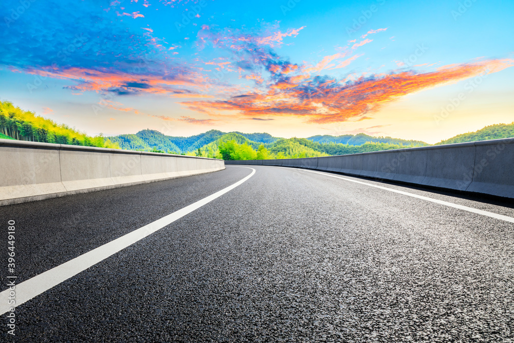 Country asphalt road and green tea plantation with bamboo forest natural landscape.