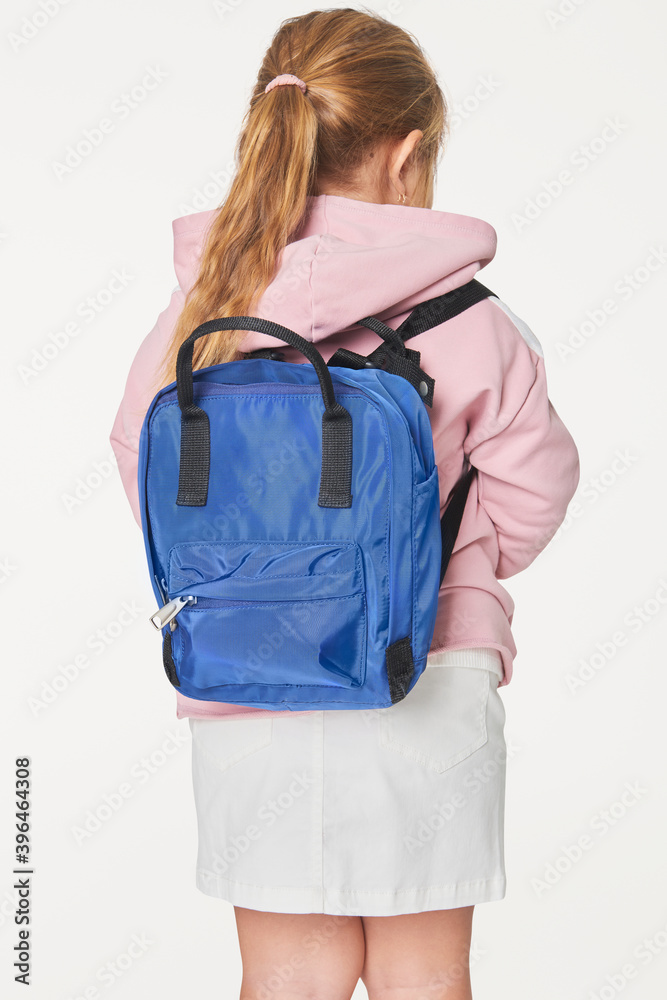 Girl with blue school bag in studio