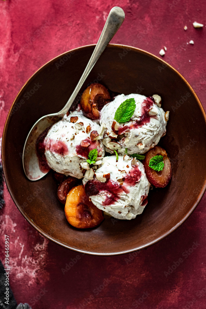 Ice cream roasted plums with chopped hazelnut