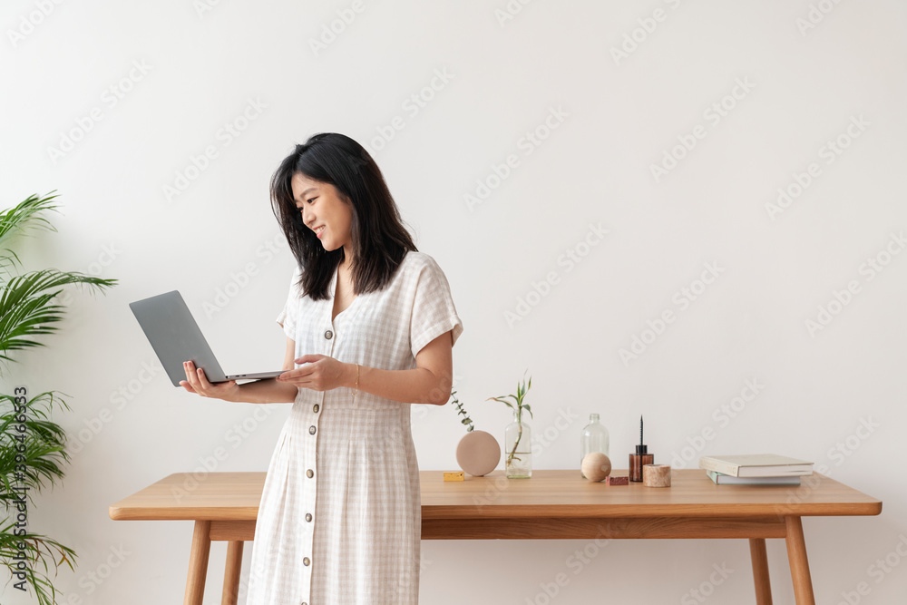 Happy Asian woman working from home