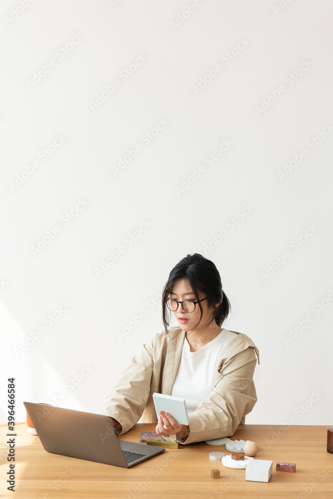 Studious Asian woman working at home using a laptop