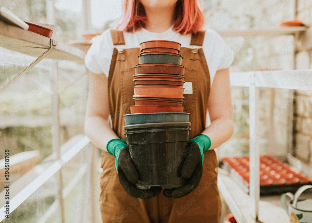 Gardener holding empty flower pots