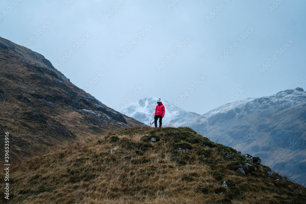 Female photographer on top of a hill at Glen Etive, Scotland